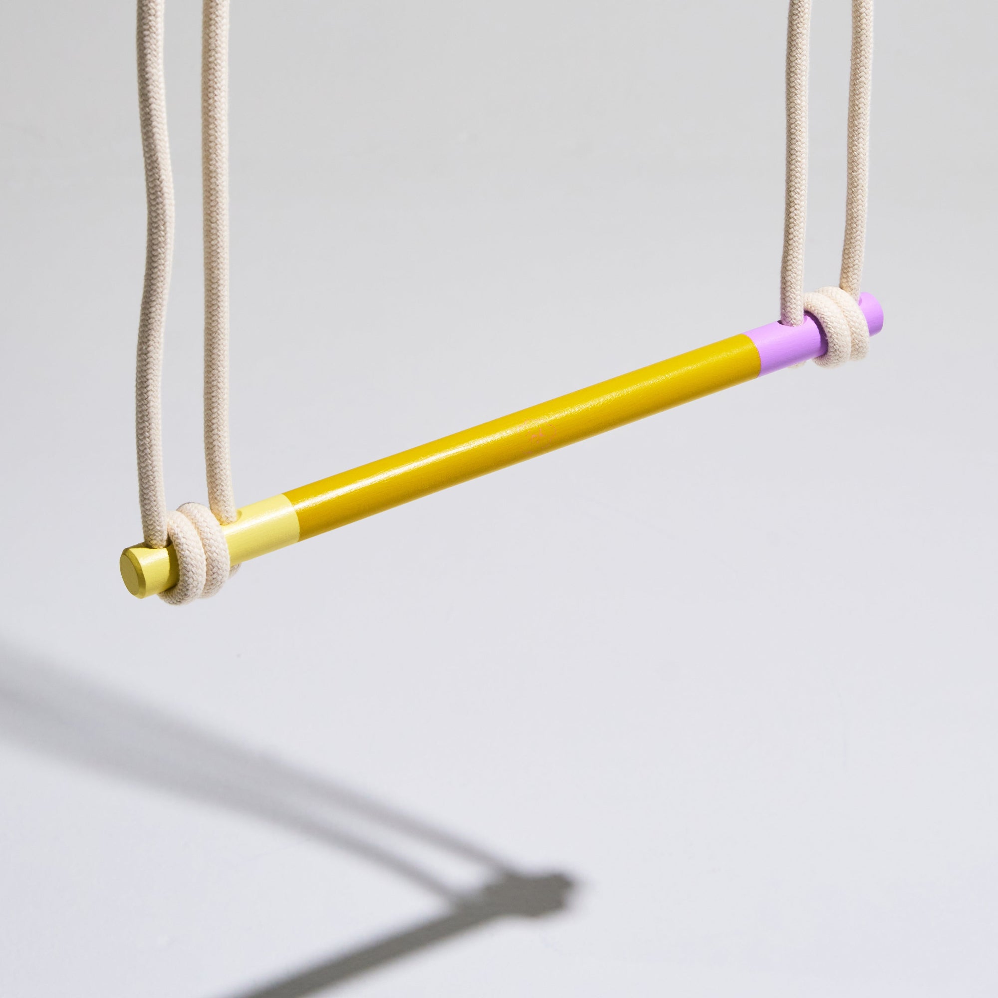 Yellow and purple swing on a gray background